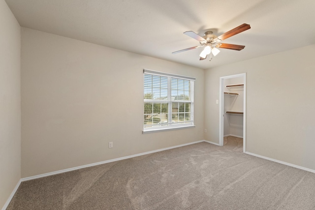 unfurnished room with ceiling fan, baseboards, and carpet flooring