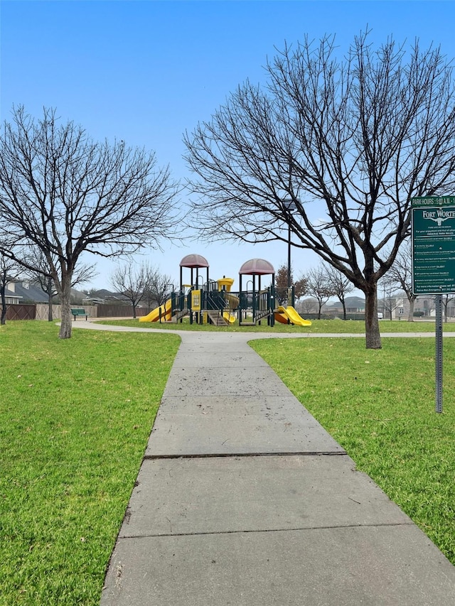 view of home's community featuring a lawn and playground community