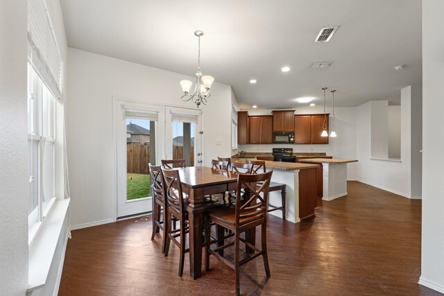 living area with ceiling fan, a brick fireplace, wood finished floors, and a wealth of natural light