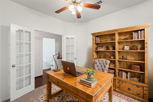 spare room featuring a ceiling fan, light colored carpet, visible vents, and baseboards