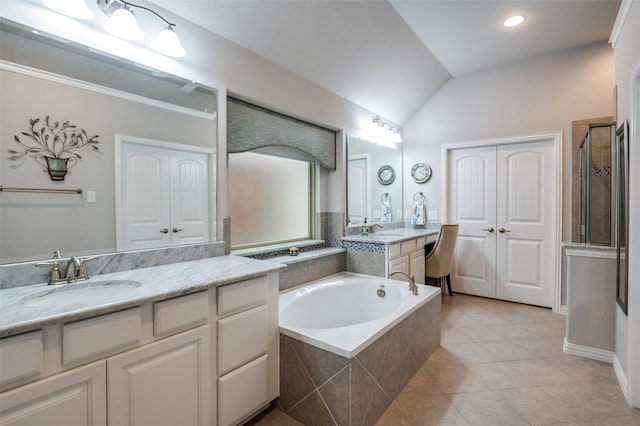 bathroom with lofted ceiling, vanity, shower with separate bathtub, and tile patterned flooring