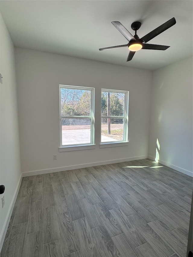 spare room with hardwood / wood-style floors and ceiling fan