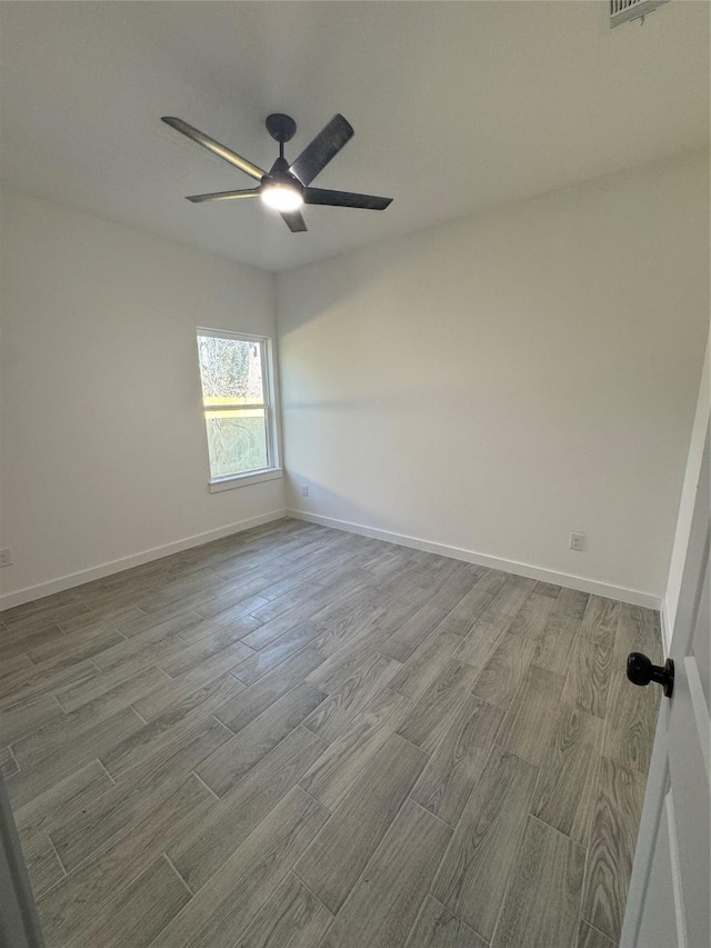 unfurnished room featuring hardwood / wood-style flooring and ceiling fan