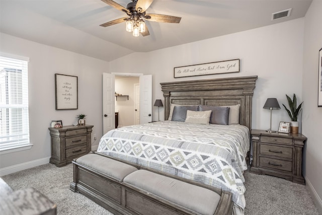 bedroom with ceiling fan, lofted ceiling, light colored carpet, and multiple windows