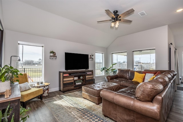 living room featuring dark wood-type flooring, plenty of natural light, and vaulted ceiling