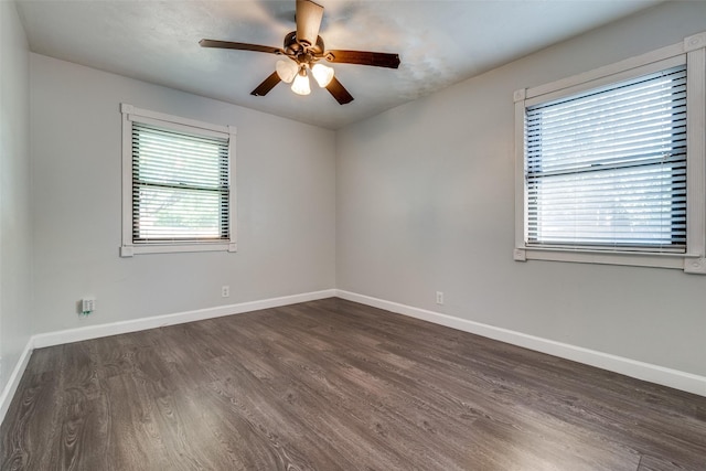 unfurnished room featuring dark wood-type flooring and ceiling fan