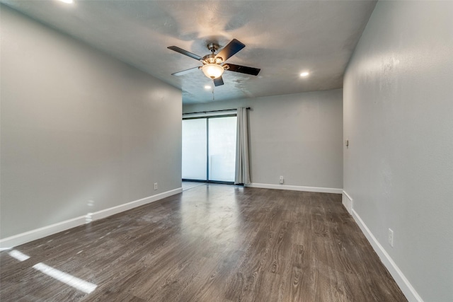 empty room featuring dark hardwood / wood-style floors and ceiling fan