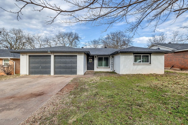 ranch-style house featuring a garage and a front yard