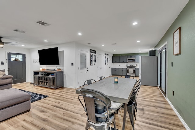 dining area with ceiling fan and light hardwood / wood-style floors