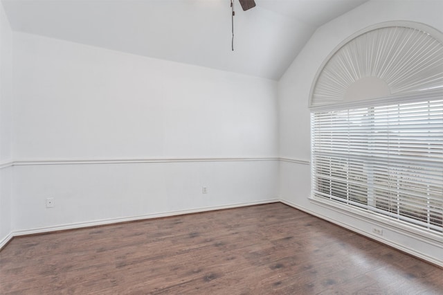 empty room featuring ceiling fan, lofted ceiling, and dark hardwood / wood-style floors