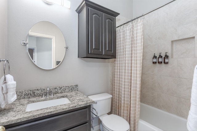 full bathroom with vanity, shower / tub combo, and toilet