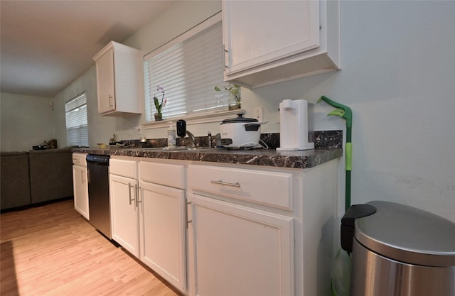 kitchen featuring sink, light wood-type flooring, and white cabinets