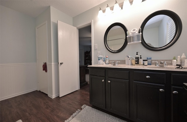 bathroom featuring vanity, hardwood / wood-style floors, and a textured ceiling