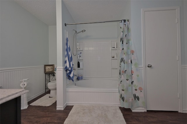 full bathroom featuring shower / tub combo with curtain, vanity, wood-type flooring, a textured ceiling, and toilet