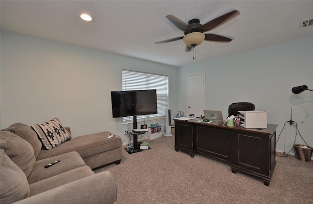 home office featuring light carpet and ceiling fan