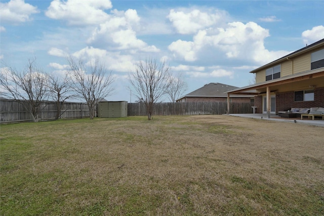 view of yard with a storage unit and a patio area