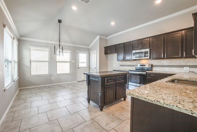 kitchen featuring a kitchen island, pendant lighting, lofted ceiling, ceiling fan, and stainless steel appliances