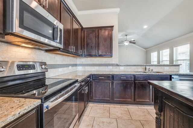 kitchen featuring hanging light fixtures, vaulted ceiling, a healthy amount of sunlight, and a kitchen island