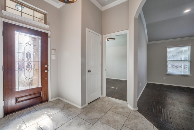 foyer featuring ornamental molding and a healthy amount of sunlight