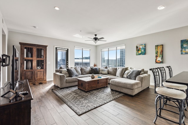 living room with dark hardwood / wood-style floors and ceiling fan