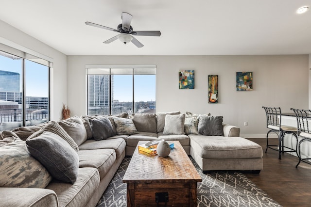 living room with ceiling fan, dark hardwood / wood-style flooring, and a wealth of natural light