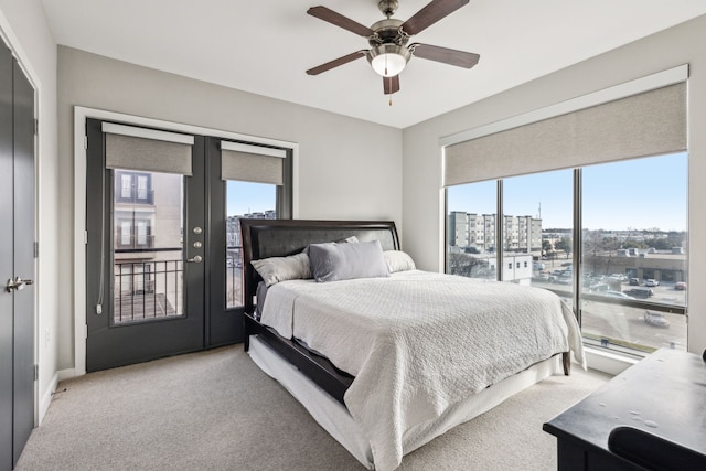 bedroom with french doors, ceiling fan, light colored carpet, and access to outside