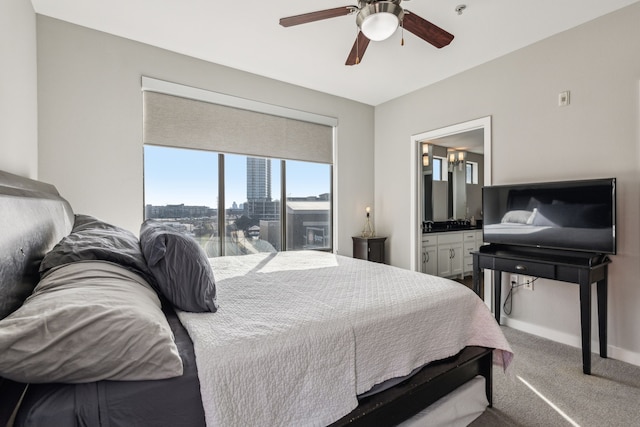 bedroom featuring connected bathroom, ceiling fan, and carpet flooring