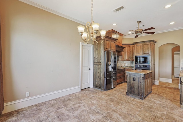 kitchen featuring crown molding, a center island, black microwave, stainless steel fridge, and backsplash