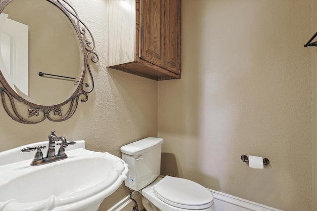 bathroom with toilet and sink