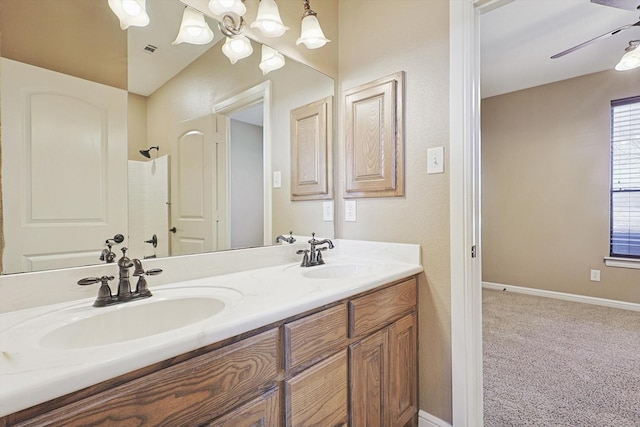 bathroom featuring vanity, ceiling fan, and walk in shower