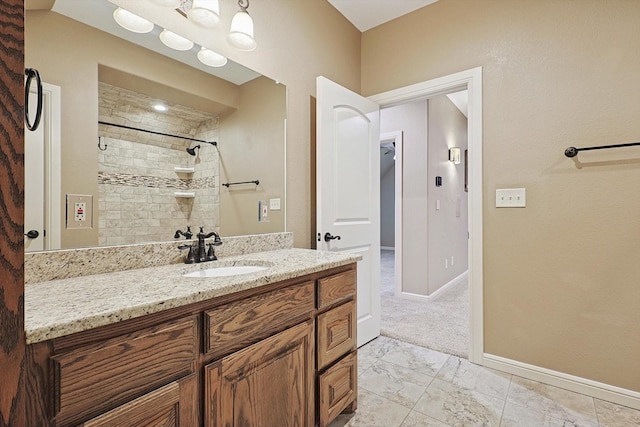 bathroom featuring vanity and a tile shower