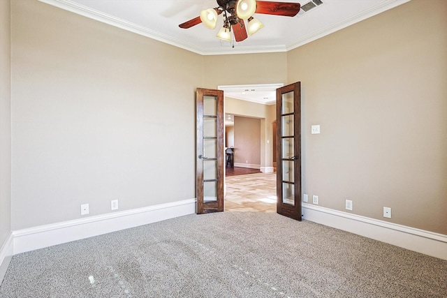 carpeted spare room with crown molding, french doors, and ceiling fan