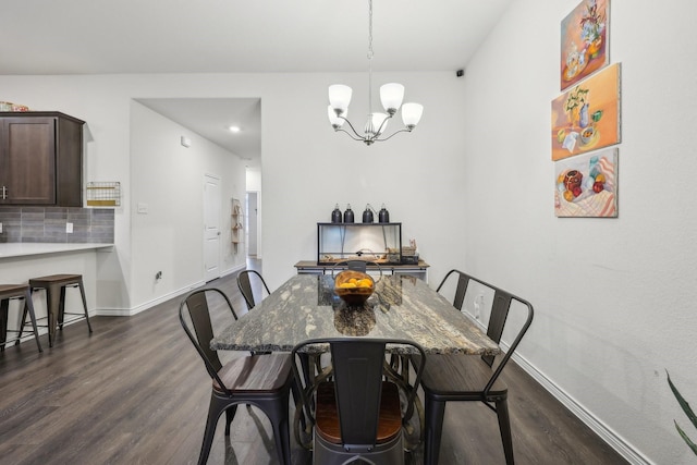 dining room featuring an inviting chandelier and dark wood-type flooring