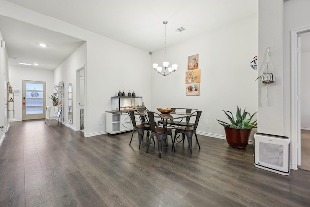 dining area with a notable chandelier and dark hardwood / wood-style floors