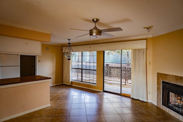 interior space featuring tile patterned flooring, a tile fireplace, ornamental molding, and ceiling fan