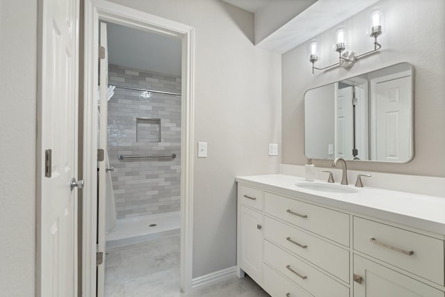 bathroom with vanity and a tile shower