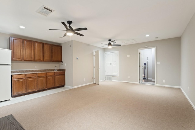 kitchen featuring light colored carpet, ceiling fan, and white refrigerator