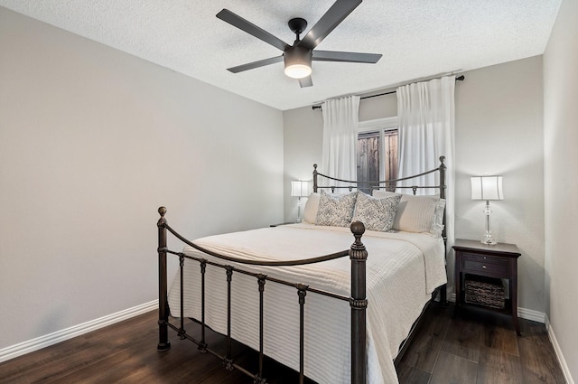 bedroom with ceiling fan, dark wood-type flooring, and a textured ceiling