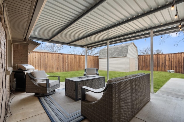 view of patio featuring a grill, an outdoor living space with a fire pit, and a storage unit