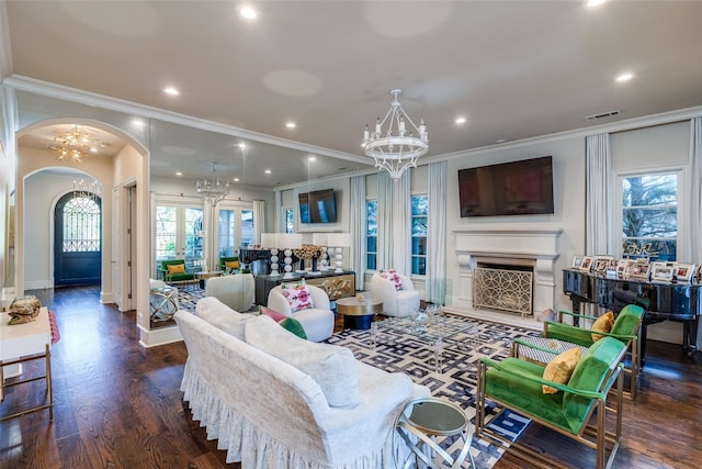 living room featuring ornamental molding, plenty of natural light, and a chandelier