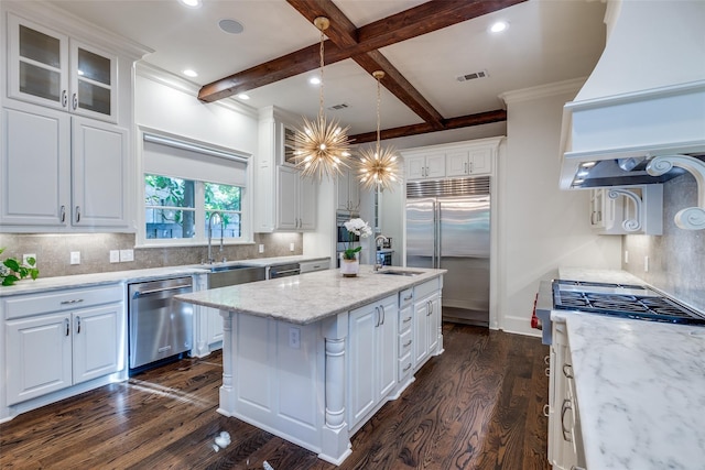 kitchen featuring stainless steel appliances, dark hardwood / wood-style flooring, a kitchen island, and white cabinets