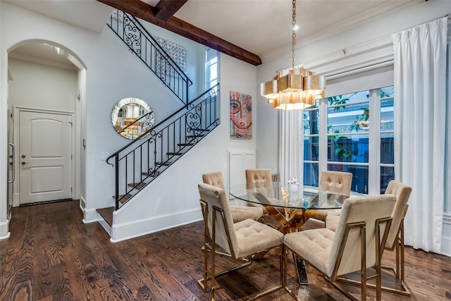 dining space with dark hardwood / wood-style flooring, beam ceiling, ornamental molding, and a chandelier