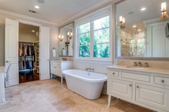 bathroom with ornamental molding, vanity, and separate shower and tub