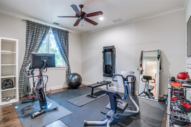 workout room featuring ornamental molding, dark wood-type flooring, built in features, and ceiling fan