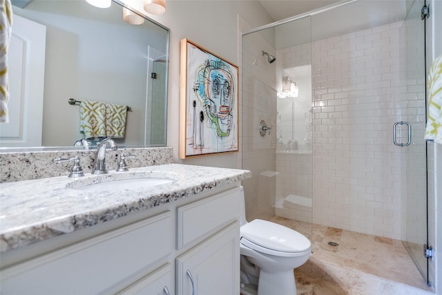 bathroom featuring walk in shower, vanity, and toilet