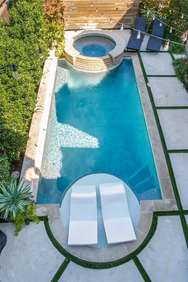 view of pool featuring an in ground hot tub