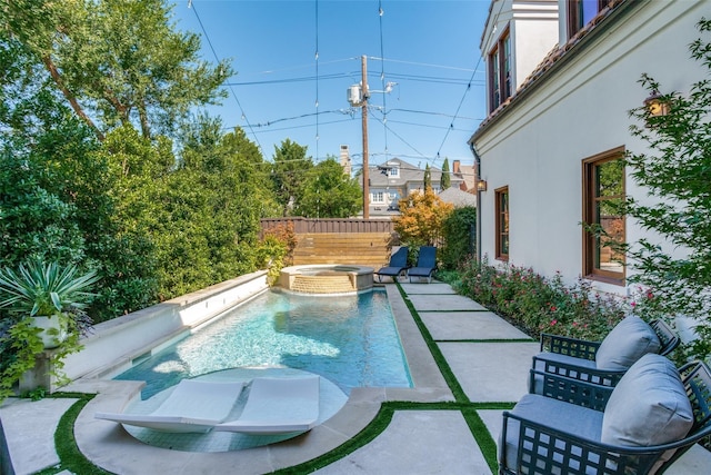 view of pool featuring an in ground hot tub and a patio