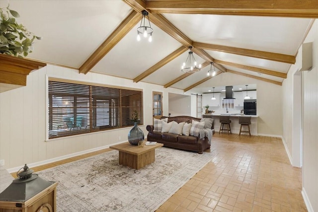 living room with lofted ceiling with beams and a notable chandelier