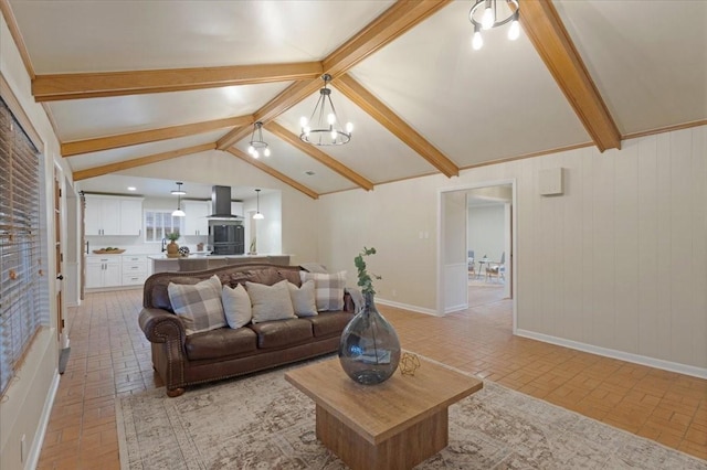 living room with a notable chandelier and lofted ceiling with beams