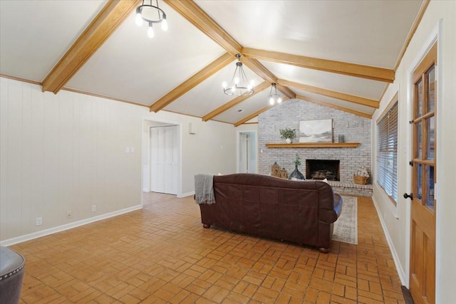 living room featuring vaulted ceiling with beams, a notable chandelier, and a fireplace